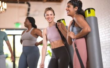 female friends with yoga mats